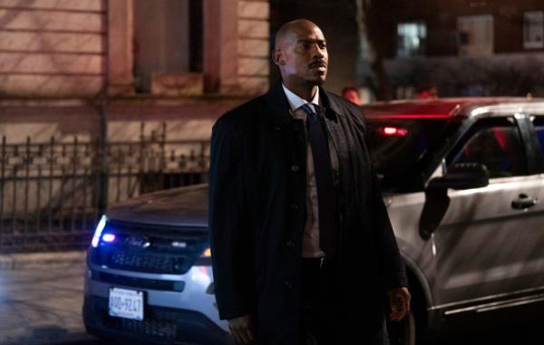 Mehcad Brooks looking serious standing in a street. 