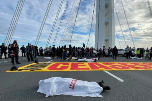 A protester lay on the ground staging a 'die in' during the demo<em></em>nstration on Thursday morning