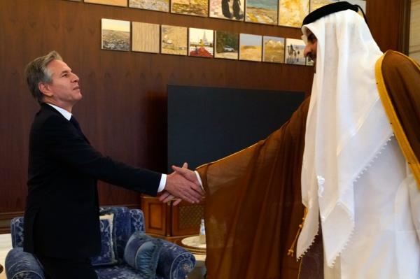 U.S. Secretary of State Antony Bl<em></em>inken, left, and Qatari Emir Sheikh Tamim bin Hamad Al Thani shake hands before their meeting in Lusail, Qatar, Friday Oct. 13, 2023.