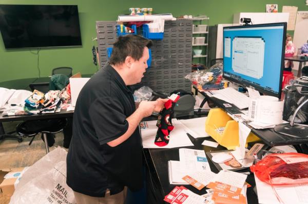John Cro<em></em>nin is seen packing up a customer's order.