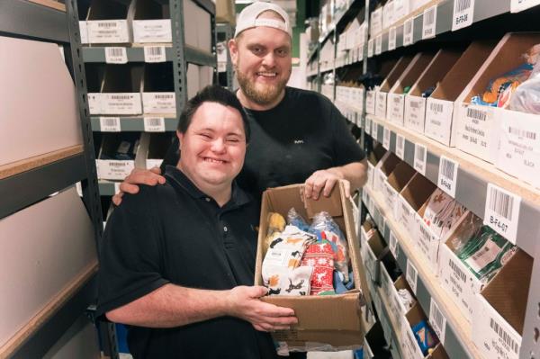 John Cro<em></em>nin is seen with his older brother Jamie as they both fulfill an order in their sock warehouse.