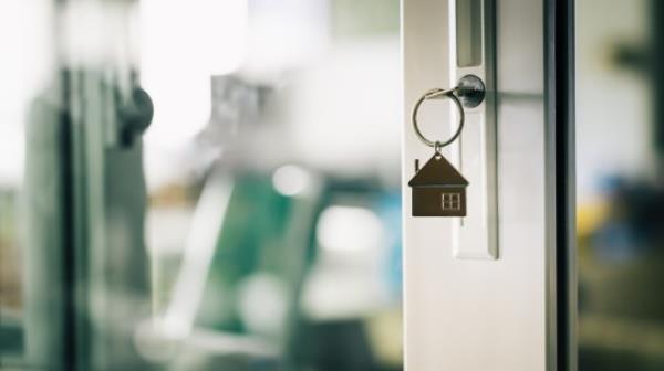 House model and key in house door. Real estate agent offer house, property insurance and security, affordable housing concepts