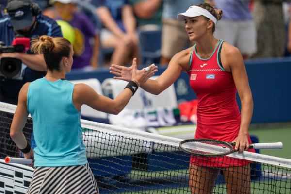 Rebeka Masarova and Maria Sakkari shake hands.