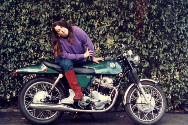 Elliot poses for a portrait on a motorcycle for her 