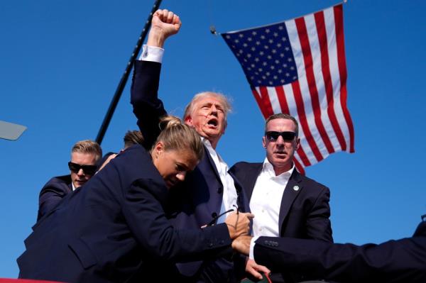 Trump is surrounded by U.S. Secret Service agents at a campaign rally following an assassination attempt on July 13.