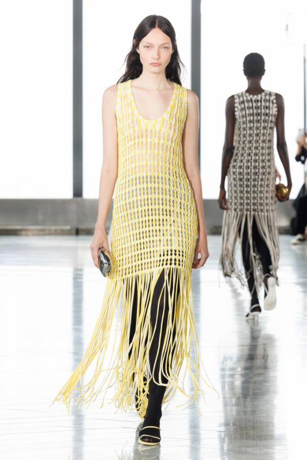 A woman modeling a yellow dress at the ALEXA SIMKHAI runway during SS25 New York Fashion Week